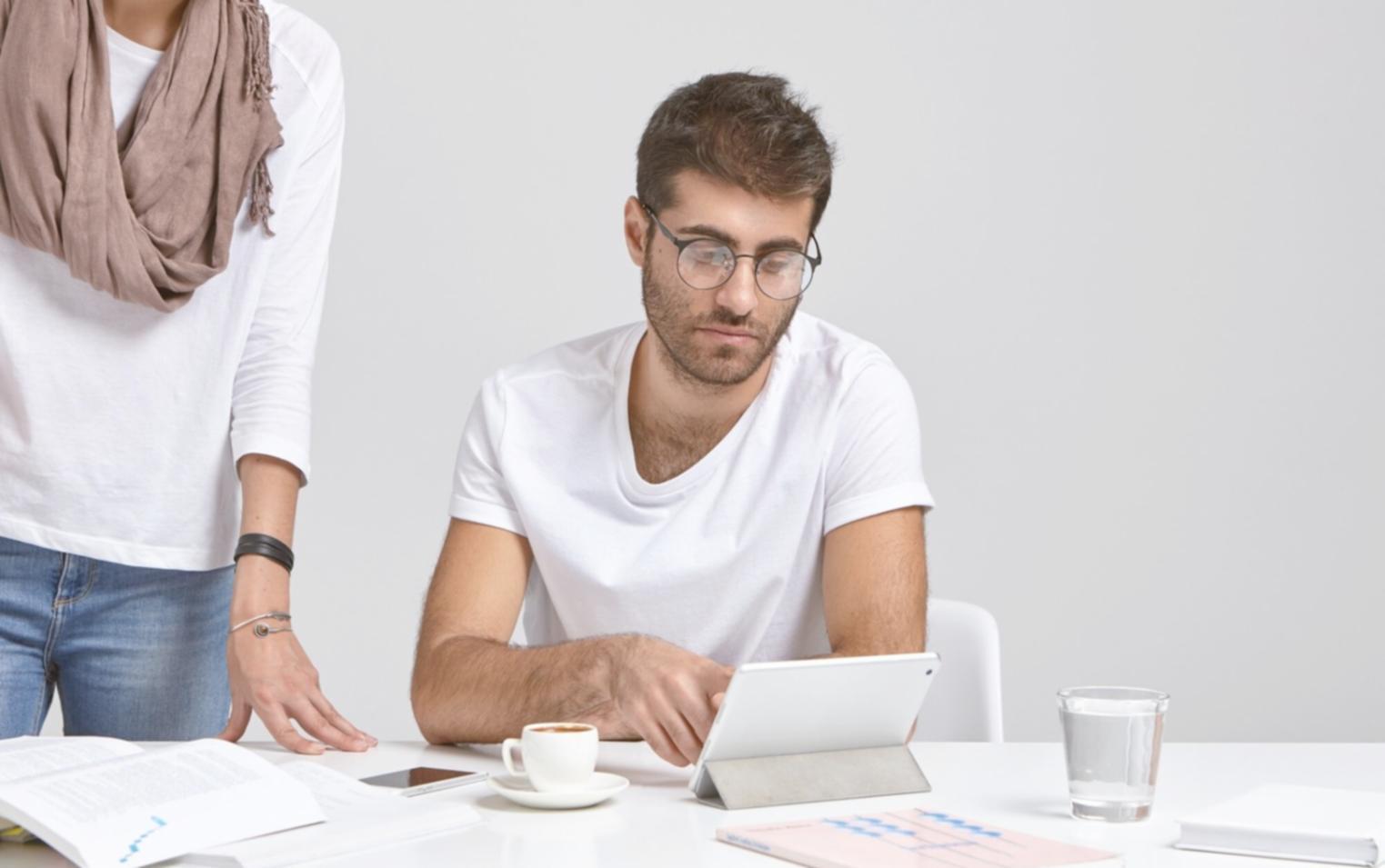 Financial analyst reviewing complex financial statements and charts on multiple computer screens
